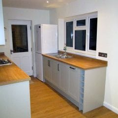 Grey shaker style kitchen refurbishment with wooden worktops and flooring, Thomson Properties