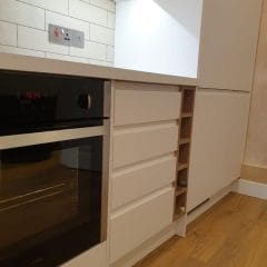 White kitchen cupboards and brick tiles kitchen installer Surrey Thomson Properties