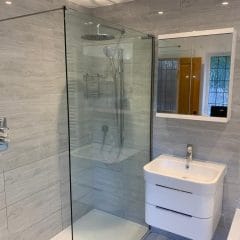 Rain shower with white bathroom unit and towel rail - Thomson Properties