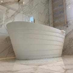 Freestanding bath, marble wall and floor tiles, bathroom refurbishment by Thomson Properties