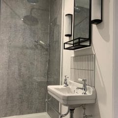Grey bathroom refurbishment by Thomson Properties, kitchen and bathroom specialists Surrey & Sussex