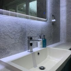 Illuminated bathroom mirror surround