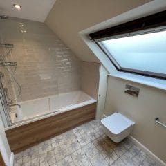 Bathroom installation with patterned floor tiles and brick wall tiles Surrey Thomson Properties