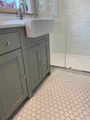 Grey bathroom units and hexagonal floor tiles, fitted by Thomson Properties