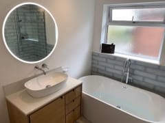 Freestanding bath and illuminated mirror, bathroom refurbishment by Thomson Properties