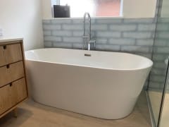 Freestanding bath, grey metro wall tiles, bathroom fitting by Thomson Properties