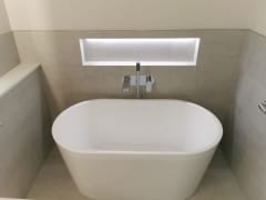 Freestanding bath and illuminated niche, luxury bathroom refurbishment by Thomson Properties