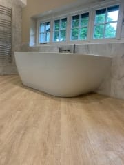 Wooden bathroom flooring and freestanding bath, bathroom refurbishment by Thomson Properties, Surrey & Sussex