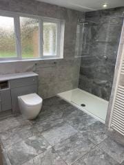 Bathroom fitting in Surrey and Sussex, on trend grey tiles