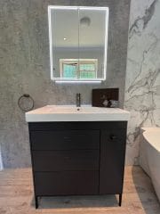 Marble tiles and black fittings finish off this bathroom refurbishment by Thomson Properties