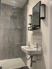 Grey bathroom refurbishment by Thomson Properties, kitchen and bathroom specialists Surrey & Sussex