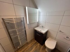 Large bathroom wall tiles with illuminated mirror, bathroom refurbishment Surrey and Sussex