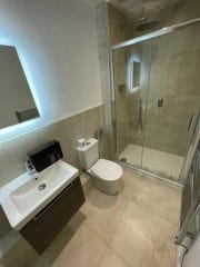 Bathroom installation with illuminated mirror, Thomson Properties, Surrey and Sussex