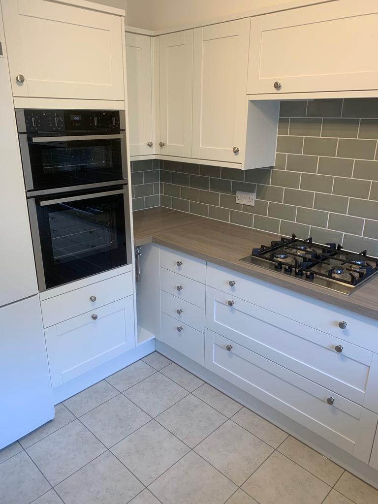 Kitchen wall grey metro tiles with white cupboards,  Thomson Properties