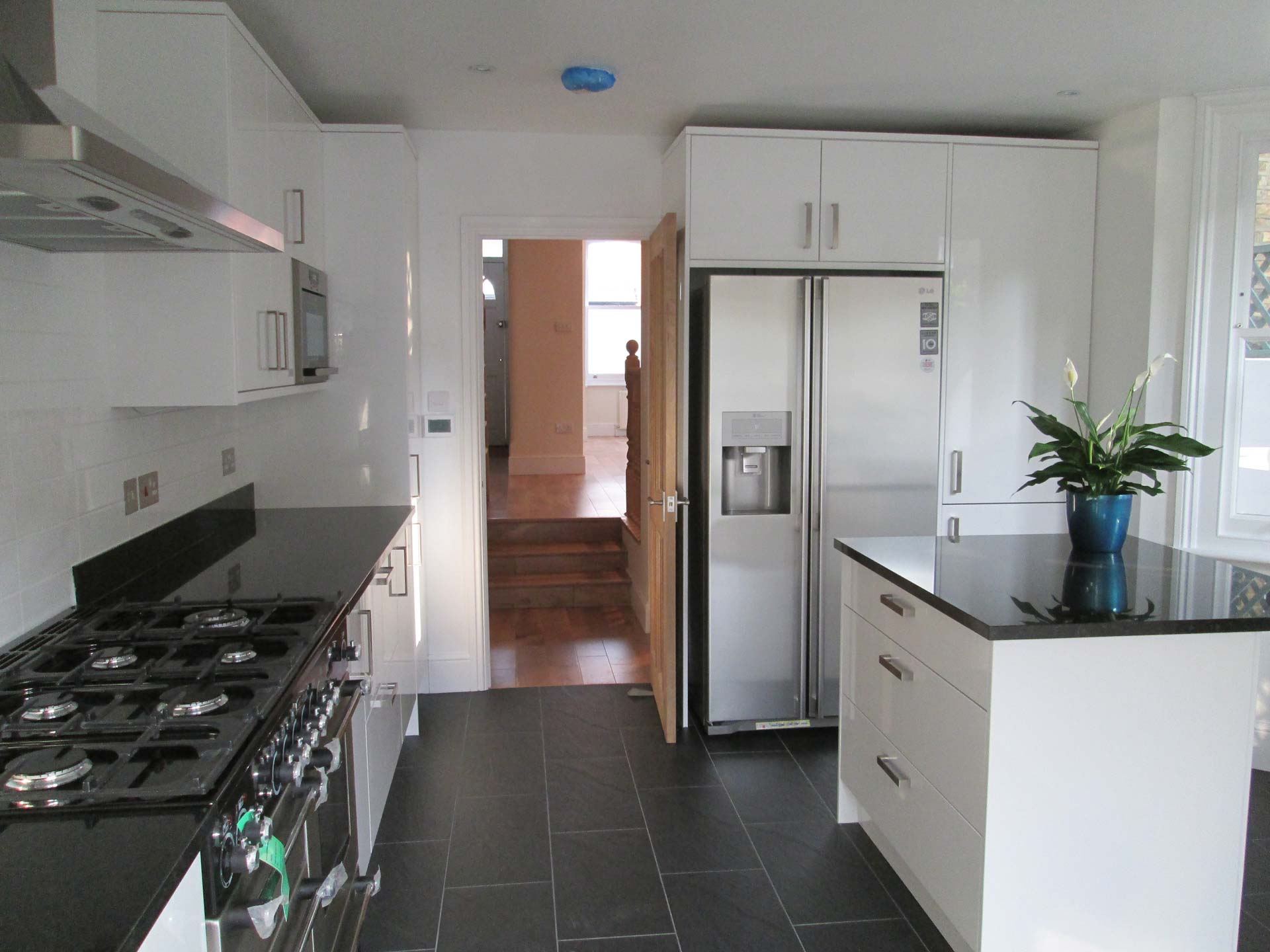 White kitchen with silver appliances fitted by Thomson Properties