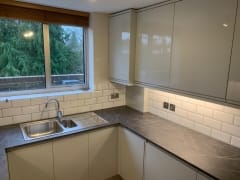 White kitchen with grey worktop kitchen fitter Surrey Thomson Properties